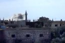 In this image taken from video obtained from the Shaam News Network, which has been authenticated based on its contents and other AP reporting, smoke rises from buildings due to heavy shelling in Daraa, Syria, on Thursday, Jan. 24, 2013. (AP Photo/Shaam News Network via AP video)