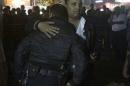 Police react as the body of another police officer is taken to an ambulance from the scene of a bomb blast in Cairo