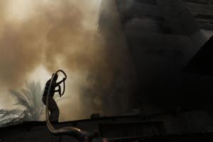 A Palestinian man battles a building on fire following &hellip;