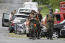 Search teams arrives at a command post for the recovery efforts from a hot air balloon accident in Ruther Glen, Va., Saturday, May 10, 2014. The body of one occupant of a hot air balloon that caught fire after striking a power line and crashed Friday has been recovered and police searched Saturday for two others feared dead, Virginia State Police said. (AP Photo/Steve Helber)
