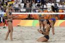 Germany's Laura Ludwig, left, and Kira Walkenhorst celebrate after beating Brazil during a women's beach volleyball semifinal match at the 2016 Summer Olympics in Rio de Janeiro, Brazil, Tuesday, Aug. 16, 2016. (AP Photo/Marcio Jose Sanchez)