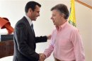 Colombia's President Santos shakes hands with Venezuela's opposition leader Capriles during a visit in Bogota