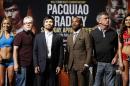 Manny Pacquiao, from the Philippines, third from left, poses with Timothy Bradley, third from right, during a news conference Wednesday, April 6, 2016, in Las Vegas. The two are scheduled to fight in a welterweight title fight Saturday in Las Vegas. Trainer Freddie Roach is second from left, and trainer Teddy Atlas is second from right. (AP Photo/John Locher)