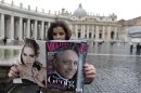 A woman holds a copy of Italy's Vanity Fair showing Archbishop Ganswein on cover in St Peter's Square at the Vatican