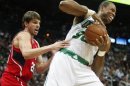 Celtics center Collins grabs a rebound away from Hawks guard Korver in the first half of their NBA basketball game in Atlanta