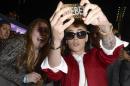 File- In this Dec. 18, 2013 file photo, singer Justin Bieber takes a "selfie" with a fan at a premiere in Los Angeles. The Los Angeles Sheriff's Department says it is searching Justin Bieber's home for evidence in an egg-tossing vandalism case involving the pop star on Thursday, Jan. 9, 2014. (AP Photo/Dan Steinberg, Invision)