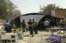 This image from AP video shows the aftermath of a suicide attack in Baqouba, some 60 kilometers (35 miles) northeast of Baghdad, Iraq, Saturday, April 6, 2013. A suicide bomber blew himself up Saturday at a lunch hosted by a Sunni candidate in Iraq's upcoming regional elections, killing scores of people, officials said. The blast ripped through a hospitality tent pitched next to the house of Muthana al-Jourani, who is running for the provincial council and held the lunch rally for supporters, councilman Sadiq al-Huseini said. (AP Photo via AP video)