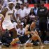 Spurs' Parker slips while being guarded by Heat's James during Game 1 of their NBA Finals basketball playoff in Miami