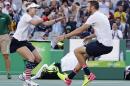 Bethanie Mattek-Sands, of the United States, left, runs into the arms of partner Jack Sock, after winning their mixed doubles gold medal match against Venus Williams and Rajeev Ram, of the United States, at the 2016 Summer Olympics in Rio de Janeiro, Brazil, Sunday, Aug. 14, 2016. (AP Photo/Charles Krupa)