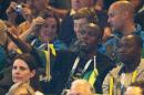 Double Olympic champion Usain Bolt of Jamaica, centre, watches the women's pool A netball match between Jamaica and New Zealand at the Commonwealth Games Glasgow 2014, in Glasgow, Scotland, Wednesday, July, 30, 2014. Bolt is the center of attention at the Commonwealth Games after mingling with British royalty on Tuesday and being quoted in a British National newspaper saying that he was 