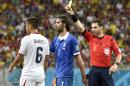 Referee Benjamin Williams, of Australia, right, gives Costa Rica's Oscar Duarte a yellow card during the World Cup round of 16 soccer match between Costa Rica and Greece at the Arena Pernambuco in Recife, Brazil, Sunday, June 29, 2014. (AP Photo/Martin Meissner)