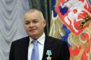 A picture taken on October 10, 2011, shows Russian television journalist Dmitry Kiselyov posing for a photo after receiving a medal of Friendship during an awarding ceremony in the Kremlin in Moscow