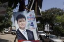 Man handles campaign billboard of Paraguay's presidential candidate Efrain Alegre of the ruling Liberal Party in Asuncion