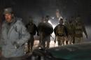 Afghan security forces arrive at the scene of an explosion in Kabul