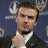 FILE - In this Jan. 19, 2012 file photo, Los Angeles Galaxy's David Beckham fixes his tie during a news conference in Los Angeles. Beckham says he is retiring from soccer at the end of the season. The 38-year-old Beckham recently won a league title in a fourth country with Paris Saint-Germain. He has become a global superstar since starting his career at Manchester United.  (AP Photo/Jae C. Hong, File)