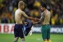 Japan's Keisuke Honda (L) exchanges jersey's with Australian player Tim Cahill