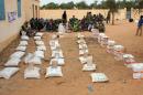 A handout picture released by the NGO Islamic relief on December 12, 2012 shows inhabitants gathered during a distribution of food from the UN World Food Programme in Gourma Rharous near Timbuktu