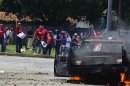 Rival supporters of Venezuelan President Hugo Chavez and opposition candidate Henrique Capriles clash in Puerto Cabello