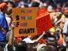 A fan in the center of a section of San Francisco Giants' fans holds up a sign during a baseball game against the San Diego Padres, Sunday, Aug. 19, 2012, in San Diego. Melky Cabrera, one of the Gaints' top hitters, was suspended this week for failing a drug test. (AP Photo/Lenny Ignelzi)