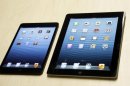 The iPad mini, at left, is shown next to the 4th generation iPad in San Jose, Calif., Tuesday, Oct. 23, 2012. The device has a screen that's about two-thirds the size of the full-size model, and Apple says it will cost $329 and up. (AP Photo/Marcio Jose Sanchez)