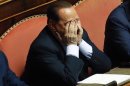 File photo of former Italian PM Berlusconi reacting during a vote session at the Senate in Rome