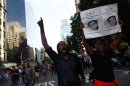 People take part in a march in reaction to the acquittal of George Zimmerman in New York