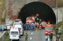 Police officers and firefighters gather in front of the Sasago Tunnel on the Chuo Expressway in Otsuki