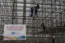 Workers set up the structure for the Arena Olimpica beach court in Copacaban beach where the Beach volleyball tournament will be held in the upcoming Olympic Games, in Rio de Janeiro on June 6, 2016