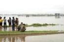 North Koreans are seen at a flooded village in Anju