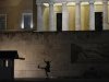 A Greek presidential guard marches past the Monument of the Unknown Soldier in Athens