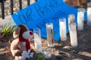 A stuffed animal, candles and a sign are part of a makeshift memorial near the Inland Regional Center on December 5, 2015, in San Bernardino, California