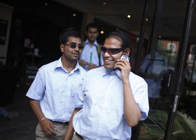 Visually impaired waiters walk out of Nepal&#39;s first blind restaurant as they wait for customers in Kathmandu