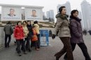 People walk near giant portraits of late North Korean leaders, Kim Il Sung, left, and his son Kim Jong Il, in Pyongyang, North Korea, Tuesday, Jan. 29, 2013. North Korea appears all set to detonate an atomic device, but confirming the explosion when it takes place will be virtually impossible for outsiders, specialists said Tuesday. North Korea watchers in South Korea are speculating diverse dates for a possible nuclear test, with some predicting that could happen as early as this week and others choosing the days just before the Feb. 16 birthday of Kim Jong Il. (AP Photo/Kyodo News) JAPAN OUT, MANDATORY CREDIT, NO LICENSING IN CHINA, HONG KONG, JAPAN, SOUTH KOREA AND FRANCE