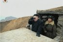 Still image taken from video shows North Korean leader Kim Jong-un looking through a pair of binoculars at an undisclosed location