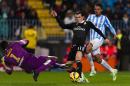 Real Madrid's Gareth Bale from Wales, center, duels for the ball against CF Malaga's goalkeeper Carlos Kameni from Cameroon, left, and Welligton Robson Pena de Oliveira from Brazil, right, during a Spanish La Liga soccer match between Malaga and Real Madrid at La Rosaleda stadium in Malaga, Spain, Saturday Nov. 29, 2014. (AP Photo/Daniel Tejedor)