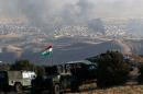 Iraqi Kurdish forces are seen stationed on a hill top as smoke billows during an operation by Iraqi Kurdish forces backed by US-led strikes in the northern Iraqi town of Sinjar on November 12, 2015