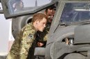 FILE - Photo dated 7/9/2012 of Britain's Prince Harry examining the cockpit of an Apache helicopter with a member of his squadron (name not provided) at Camp Bastion in Afghanistan, where he will be operating from during his tour of duty as a co-pilot gunner. The prince was unharmed after an attack on the Camp Bastion compound in which two US Marines were killed and several more wounded Saturday Sept. 15, 2012. US officials said the attack last night was by heavily-armed insurgents and involved a range of weaponry, including mortars, rockets or rocket-propelled grenades, as well as small arms fire. Harry was about two kilometres away with other crew members of the Apache attack helicopters, when the attack took place, sources said. (AP Photo/John Stillwell/pool file)