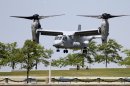FILE - In this Sunday, June 10, 2012 file photo, a Marine MV-22 "Osprey" tilt-rotor aircraft lands at Voinovich Park in downtown Cleveland. The United States is going ahead with a plan to deploy its Osprey military transport aircraft to Japan despite strong opposition from residents over safety issues. A city official in Iwakuni, where the aircraft are to be briefly stationed before their deployment on the southern island of Okinawa, said Wednesday, July 4, 2012, the first 12 Ospreys have left port in San Diego and are expected to arrive by the end of the month. (AP Photo/Mark Duncan, File)