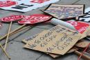Anti-eviction activist placards lie strewn on the footpath during a demonstration in Valladolid, Spain, on March 19, 2015