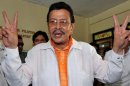 Joseph Estrada flashes the victory sign after casting his ballot at a polling station in Manila, on May 10, 2010