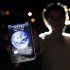 A man poses with an iPhone during Earth Hour in the center of Brasilia