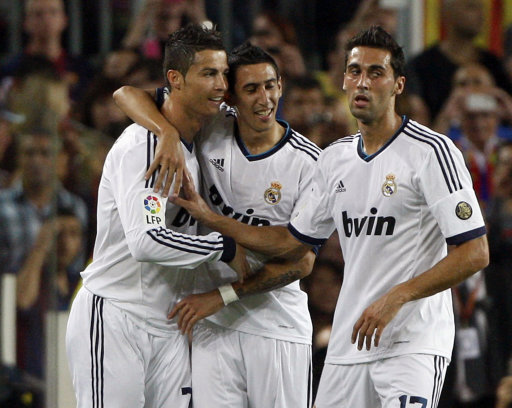 Real Madrid's Ronaldo celebrates with di Maria and Arbeloa after scoring against Barcelona during their Spanish first division soccer match at Nou Camp stadium in Barcelona