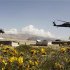 U.S. military Black Hawk helicopters fly past an Afghan graveyard in Forward Operating Base Methar Lam, in Laghman province