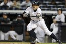 New York Yankees' Ichiro Suzuki attempts a bunt against the Detroit Tigers in the first inning during Game 1 in their MLB ALCS playoff baseball series in New York