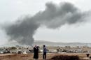 Smoke rises from the the Syrian town of Kobane after a strike from the US-led coalition, as seen from the Turkish border village of Mursitpinar, October 14, 2014