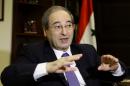 Syrian deputy foreign minister Faisal Muqdad speaks to an AFP journalist in the capital Damascus on December 19, 2013