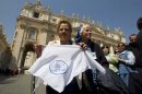 Grandmothers of the Plaza de Mayo activist Buscarita Roa, of Chile, shows a scarf with the symbol of the Grandmothers of the Plaza de Mayo association, in St. Peter's Square after meeting Pope Francis at the end of his weekly general audience at the Vatican, Wednesday April 24, 2013. Representatives from "Grandmothers of Plaza de Mayo," an activist group that searches for people missing from Argentina's "dirty war," attended Pope Francis' general audience and said they will ask him to open the church files on the country's wartime era. The former Cardinal Jorge Mario Bergoglio was the head of the Jesuit order in Argentina during the start of the 1976-82 dictatorship that kidnapped and killed thousands of people to eliminate leftist opponents. (AP Photo/Alessandra Tarantino)