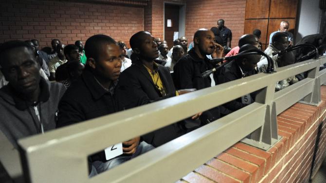 A picture taken on March 8, 2013 shows some of the South African police officers on trial in Benoni court over the death of Mido Macia, a Mozambican taxi driver who died in custody after being dragged behind a police van