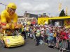 A Le Credit Lyonnais vehicle from the publicity caravan of the Tour de France travels past spectators at the start of the third stage of the 99th Tour de France cycling race between Orchies and Boulogne-sur-Mer