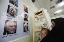 An Iranian woman looks at poster of Iranian Presidential candidates during Iranian presidential election at Shi'ite mosque in Baghdad